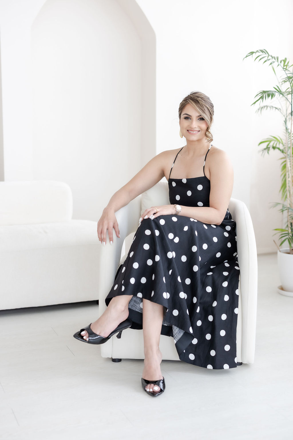 Nishka Rangwani seated in a polka-dot dress